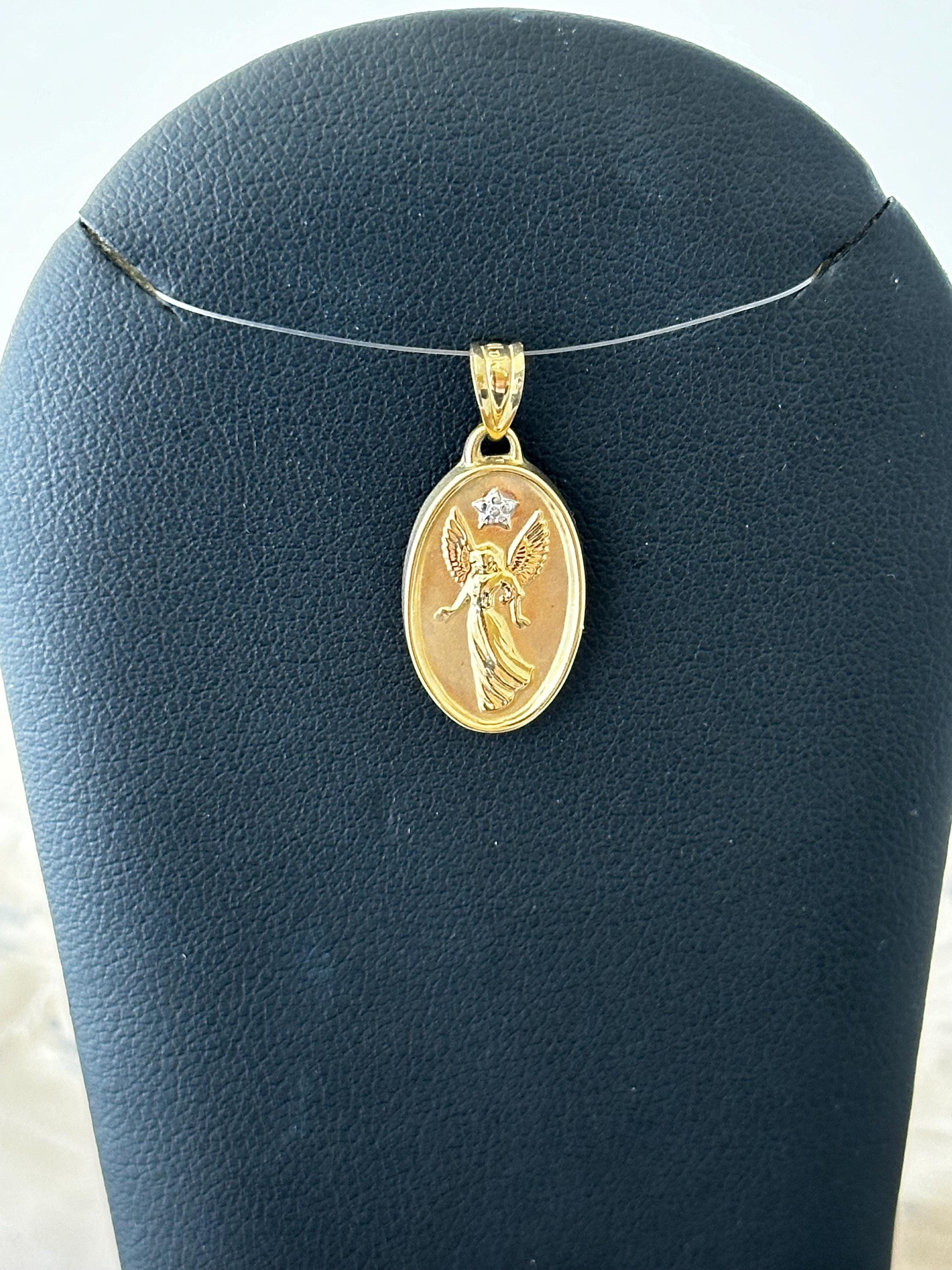 10 karat yellow gold angel pendant with diamond accent and saying.