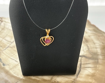 14 karat yellow gold, heart shaped double heart pendant with heart shaped ruby and diamond accent.