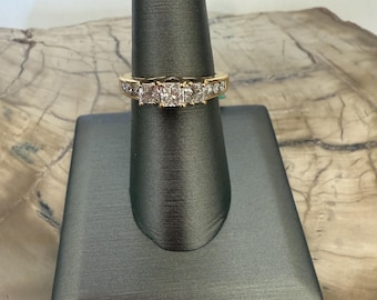 14 karat yellow gold, 3-stone, princess cut, engagement ring with round diamond accents