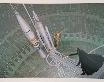 May include: A scene from Star Wars featuring Darth Vader and a character in a brown jumpsuit standing on a metal platform. The platform is attached to a large, cylindrical structure with a spaceship docked to it. The background is a dark, circular space with a green and gray pattern.