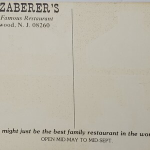 May include: A vintage postcard for Ed Zaberer's World Famous Restaurant in Wildwood, New Jersey. The postcard features the restaurant's name and address, along with the text "We might just be the best family restaurant in the world... Open Mid-May to Mid-Sept."