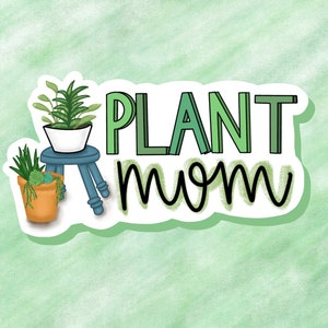 May include: A sticker with the text "PLANT mom" in black and green lettering. The sticker features a cartoon illustration of a green plant in a white pot on a blue stool.