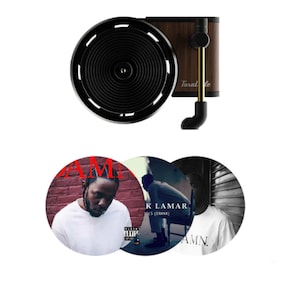 May include: A black and wood turntable with a gold needle. Three vinyl records are shown with the album cover art featuring Kendrick Lamar's "To Pimp a Butterfly" album.