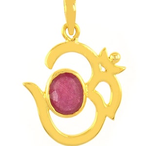 May include: Gold pendant featuring the Om symbol with a pink gemstone in the center.