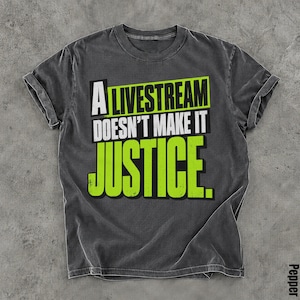 May include: A charcoal gray short-sleeve t-shirt featuring the text A LIVESTREAM DOESN'T MAKE IT JUSTICE. The word LIVESTREAM is in lime green, DOESN'T MAKE IT is in white, and JUSTICE is in large lime green block letters.