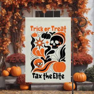 May include: A rectangular garden flag with a cream background featuring orange and black graphic illustrations of pumpkins, skulls, and stars. The text reads Trick or Treat at the top and Tax the Elite at the bottom in a bold black font.