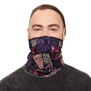 May include: A patterned neck gaiter in shades of purple, red, and black, featuring a patchwork design with QR codes and fist symbols. The neck gaiter is worn around the neck and covers the lower face.