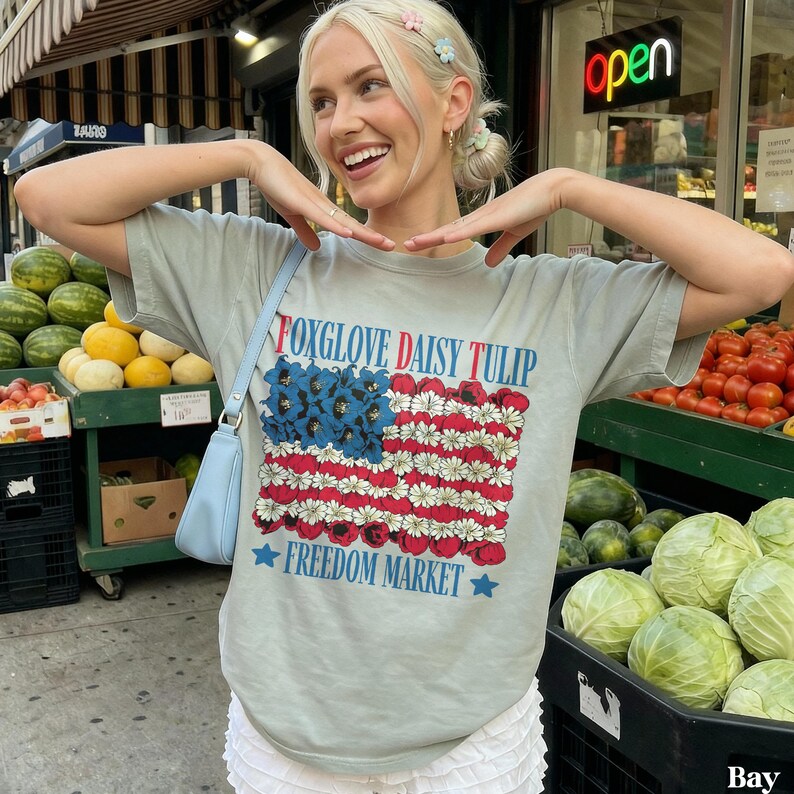 Woman wearing a t-shirt with a flag design made of daisies.