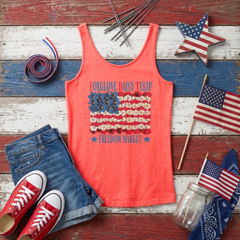 Coral tank top with a flag design of flowers, red shoes, denim shorts, and patriotic decorations.