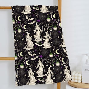 May include: Black Halloween-themed towel with a repeating pattern of witches, bats, spiderwebs, and moons. The design includes the text "Fuck Trump" in a repeating pattern. The witches are depicted in white dresses and hats.