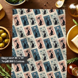 May include: A decorative cotton towel with a repeating pattern of black cat illustrations within postage stamp-like frames. The frames alternate between blue, pink, and gray backgrounds with star accents. The towel measures 18 x 30 inches.