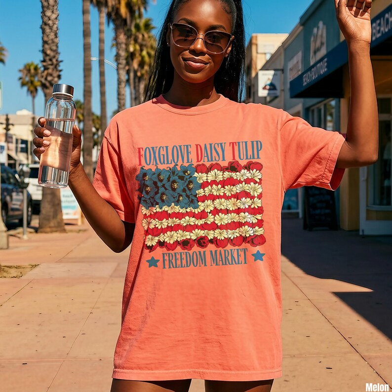 Coral t-shirt with red, white, and blue floral American flag design.