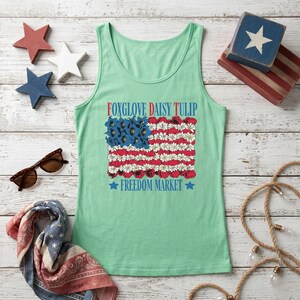 Tank top featuring a floral American flag design and text.