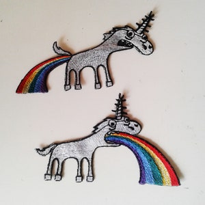 May include: Two embroidered iron-on patches of unicorns, one with a rainbow coming out of its rear end and the other with a rainbow coming out of its mouth.