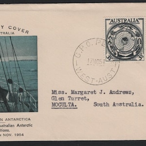 May include: A handmade wooden sign with the text "Welcome to our home" in a handwritten style. The sign is painted white with a distressed finish and features a black border. A small, decorative heart is attached to the bottom.