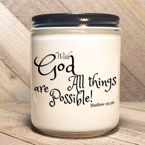 May include: White candle in a glass jar with a black lid. The candle has the text "With God All things are Possible! Matthew 19:26" printed on the front.