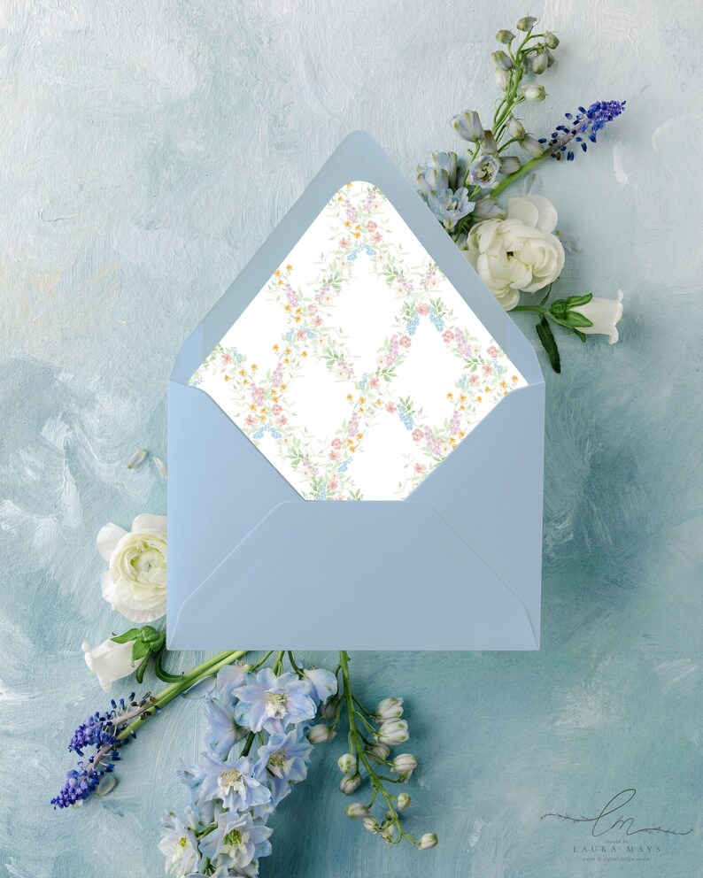 May include: A light blue envelope with a floral patterned interior, surrounded by white and blue flowers on a light blue background. The envelope is open, revealing the patterned interior.