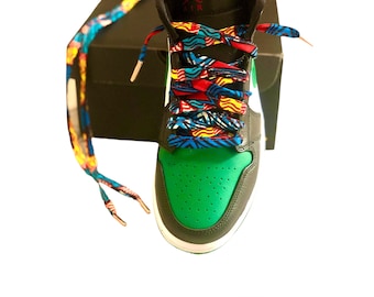 May include: Green and black sneakers with colorful patterned shoelaces. The shoelaces are 55 inches long.