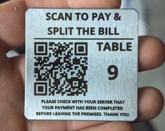 May include: A silver metal table number with a black QR code and the text "SCAN TO PAY & SPLIT THE BILL", "TABLE 9", and "PLEASE CHECK WITH YOUR SERVER THAT YOUR PAYMENT HAS BEEN COMPLETED BEFORE LEAVING THE PREMISES. THANK YOU."