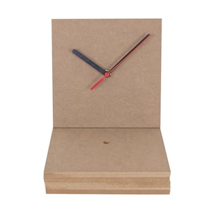 May include: A simple, unfinished wooden clock face with black and red hands. The clock face is mounted on a stack of unfinished wood.