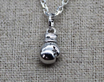 May include: Silver chain necklace with a silver boxing glove pendant.
