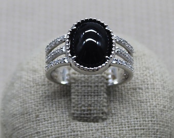 Ring in solid 925 Silver adorned with an imposing black Agate, the setting of the ring is decorated with Zirconium oxides, handmade.