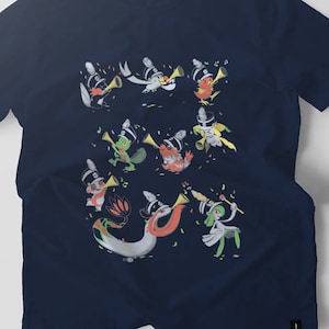 May include: A navy blue t-shirt with a graphic print of cartoon characters playing musical instruments. The characters are wearing colorful hats and holding trumpets.