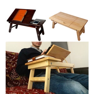 May include: A wooden laptop table with a foldable design. The table is shown in two different colours: dark brown and light wood. The table is shown being used on a sofa.