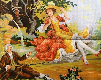 May include: Needlepoint tapestry depicting a woman on a swing, wearing a yellow dress and red skirt, with a man in a brown suit. The scene is set in a garden with trees and flowers, featuring a vintage aesthetic.