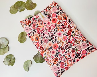 Padded fabric book pouch with button closure, pocket-sized book protection cover. Small flower pattern.