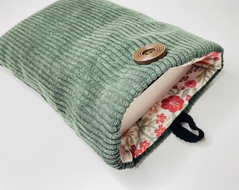 Padded fabric book sleeve with button closure, pocket-sized book cover. Green corduroy