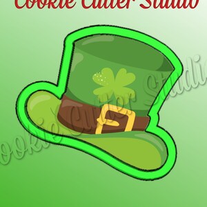 May include: Green cookie cutter shaped like a leprechaun's hat with a shamrock on top and a brown belt.  Cookie Cutter Studio.