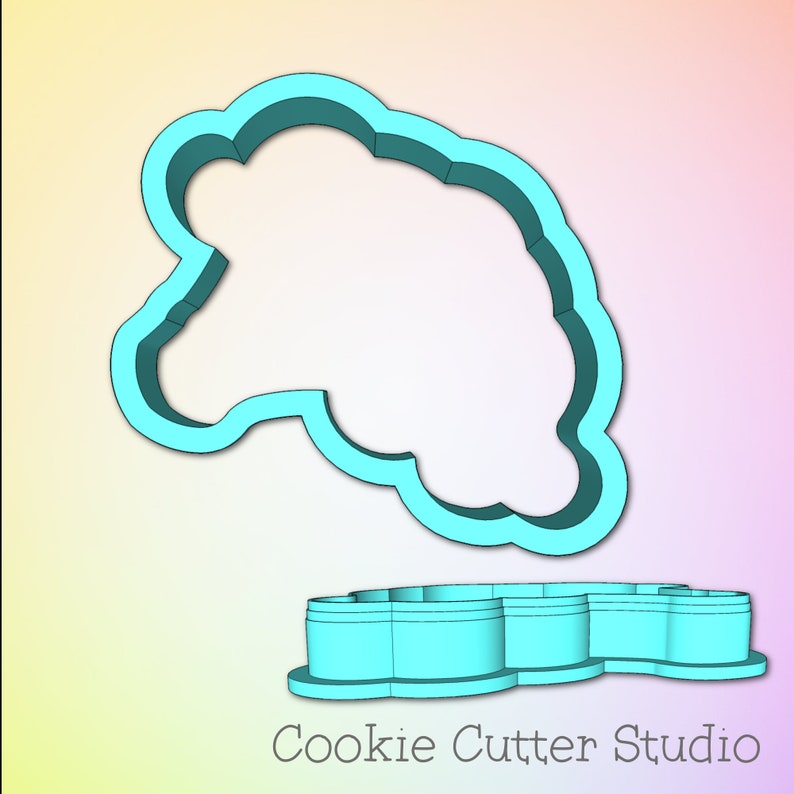 May include: A light blue plastic cookie cutter in the shape of a cloud. The cutter is shown in two parts, the top and bottom, with the top part raised above the bottom part. The text "Cookie Cutter Studio" is printed below the cutter.