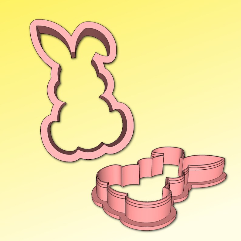 May include: Two pink plastic cookie cutters shaped like a bunny rabbit. The cutters are designed to create a detailed bunny shape with a fluffy tail and ears.