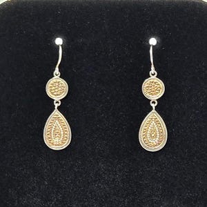 May include: A set of three ceramic mugs with a speckled, matte finish in cream, light grey, and dark grey. Each mug features a simple, minimalist design, ideal for tea or coffee.