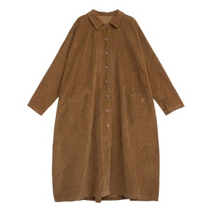 May include: A long brown corduroy shirt with a button-up front and long sleeves.