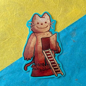 May include: A die-cut sticker featuring a tan, anthropomorphic cat-like creature with a simple line-drawn face. The creature has a rectangular door opening in its torso, with a small wooden ladder leading up to it. The text ELDRITCH RACH is visible.