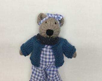 Handmade beige knitted bear, blue checked jumpsuit and headband, denim blue shoes and neck scarf, light blue cardigan.