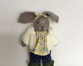 Handmade beige knitted bunny , cream cardigan, blue jeans with spots , green shoes and lemon print top and headband.