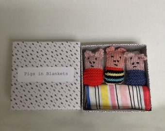 Handmade pigs  in blankets, bright colour theme , striped blank , black and white box.