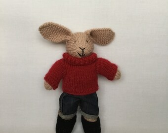 Handmade beige knitted bunny rabbit blue jeans , red jumper and black shoes.