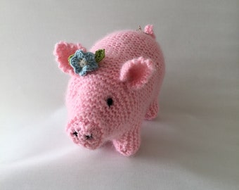 Handmade pink piggy with blue flower.