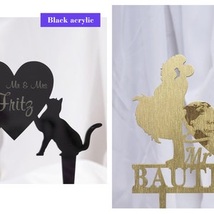 Puede incluir: Dos toppers para pastel de boda, uno de acr&iacute;lico negro con dos gatos sosteniendo un coraz&oacute;n que dice "Mr & Mrs Fritz" y el otro de madera dorada con un gallo y una mujer sosteniendo un coraz&oacute;n con un mapa del mundo y el texto "Kristen & Mary's Place" y "Mr Mrs Bautista".
