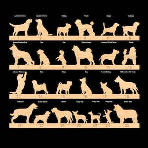 May include: A set of 25 wooden dog breed silhouettes, each numbered and labelled with the breed name. The silhouettes are cut out of light brown wood and are arranged in rows of five.