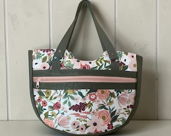 Isla bag, well constructed and attractive half moon shape, with a large zippered pocket in front and slip pockets, zippered pocket inside