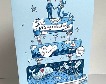 Congratulations on your wedding card - A5- a fisherman and his mermaid bride on a sea themed cake.