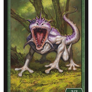 May include: A green, purple, and white frog lizard creature with a wide open mouth, standing on a green and brown background. The creature has a long tail and webbed feet. The text "FROG LIZARD" is at the top of the card. The text "3/3" is in the bottom right corner of the card. The text "MATT STAWICKI" is in the bottom left corner of the card. The text "Token 85 © 2020" is in the bottom right corner of the card.