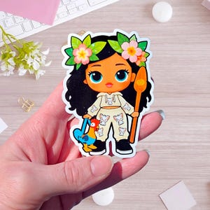 May include: A die-cut sticker featuring a cartoon character with dark curly hair adorned with pink and yellow flowers. The character wears a cream-colored hoodie and pants with a small cat print, black shoes, and holds a wooden staff and a blue rooster.