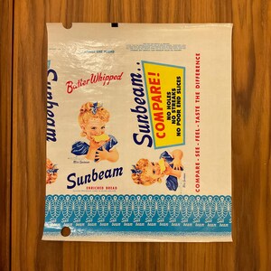 May include: Vintage Sunbeam bread bag with a white background and blue and red text. The bag features an illustration of a young girl eating bread and the words "Compare!" and "Batter Whipped."