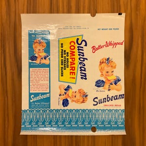May include: Vintage Sunbeam bread bag with a retro design. The bag features illustrations of a young girl eating bread, the words "Compare!" and "Batter Whipped," and the Sunbeam logo. The bag is white with blue and yellow accents.